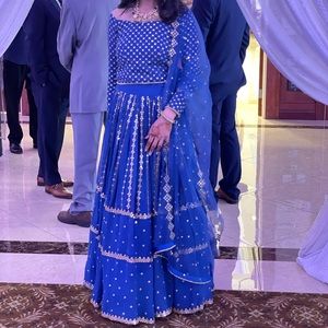 Blue Lehenga, off the shoulder with net dupatta.